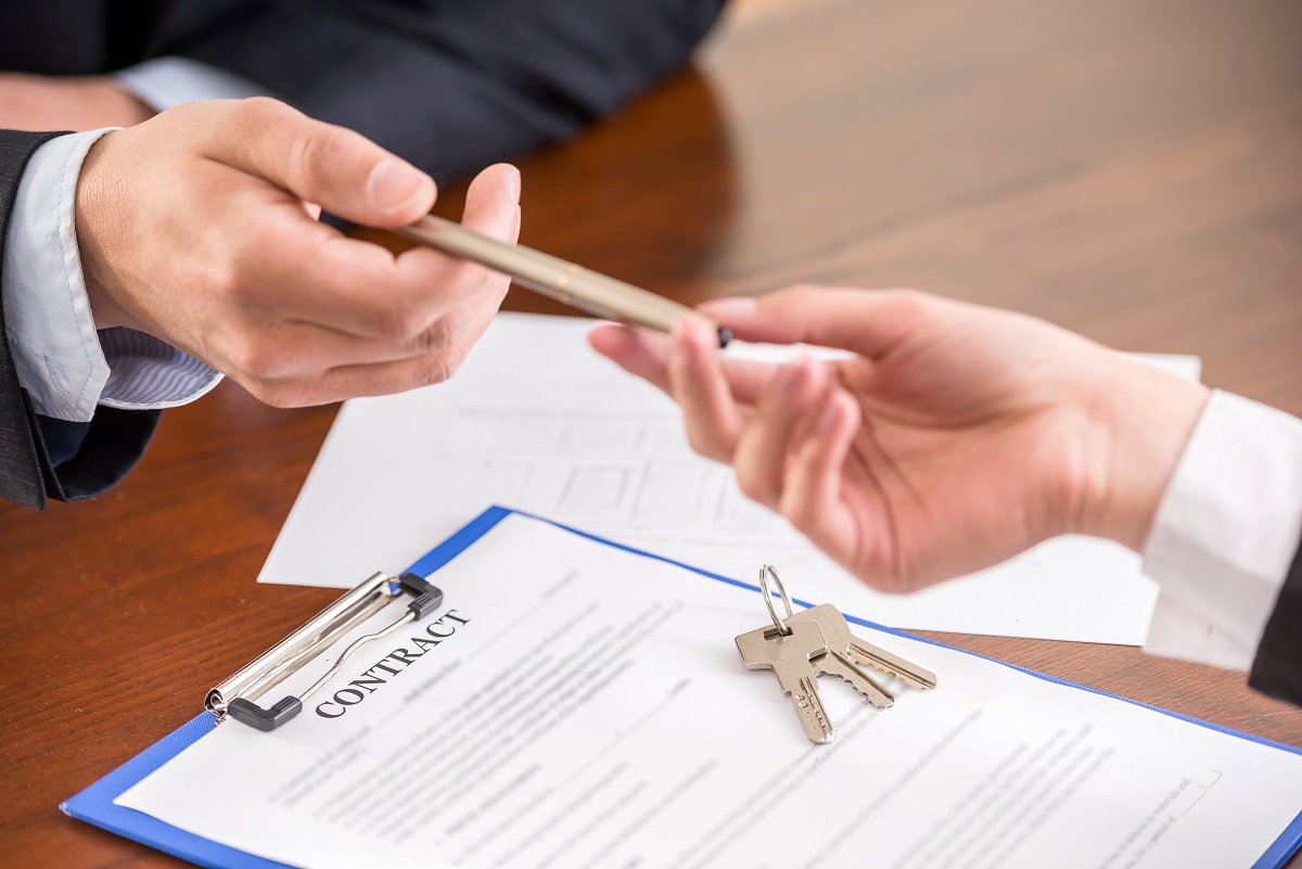 Close Up Of Hands With A Pen To Signing A Contract.