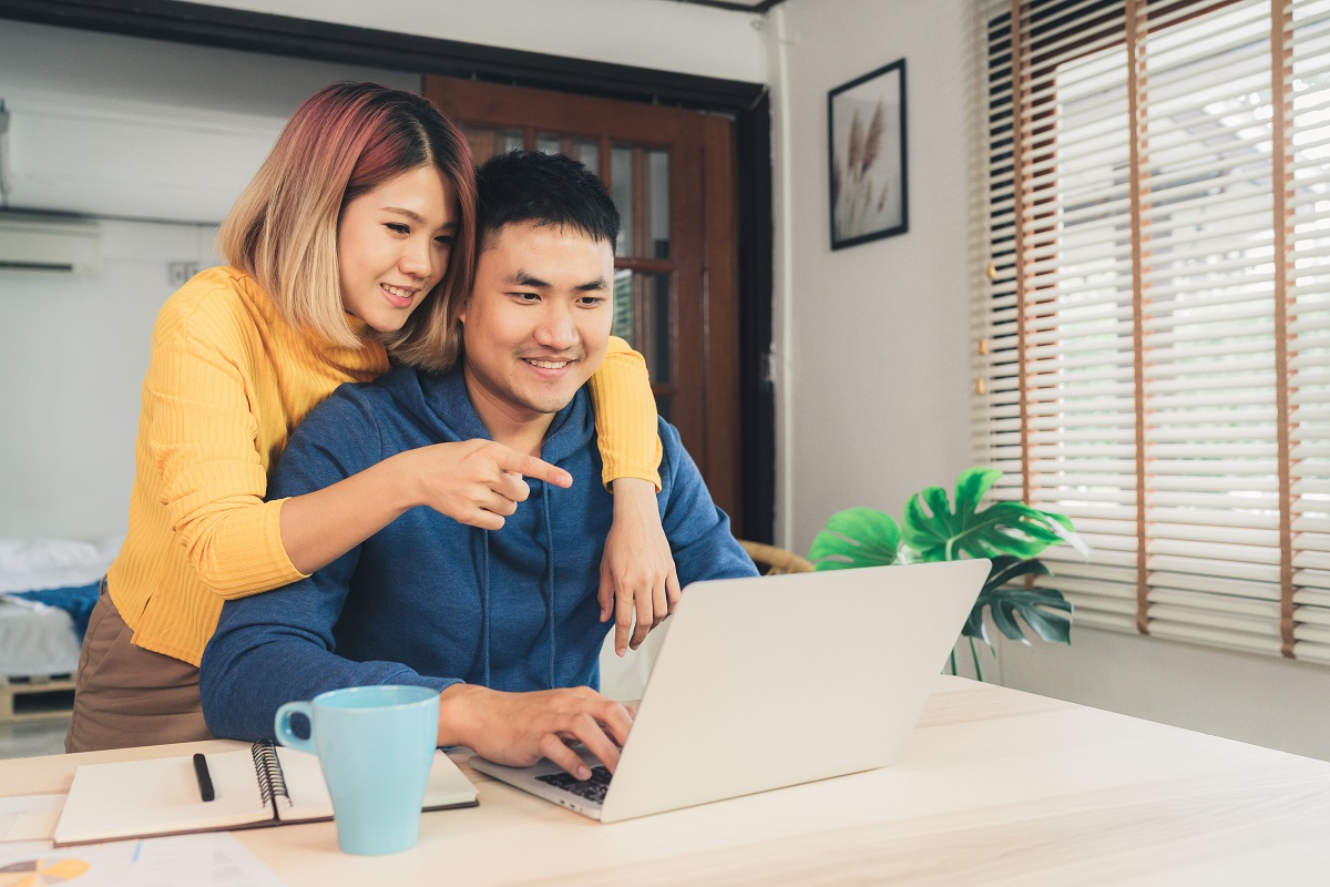 Young Asian Couple Managing Finances, Reviewing Their Bank Accou