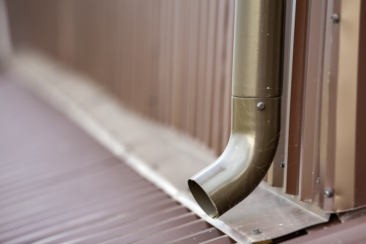 Close Up Of Brown New Gutter Metal System Pipe On Wall. Drain Pr