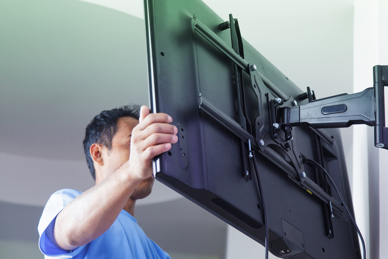 A man mounting a television