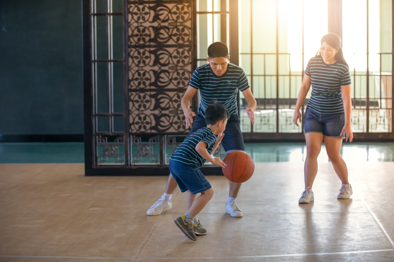 An Asian family playing basketball